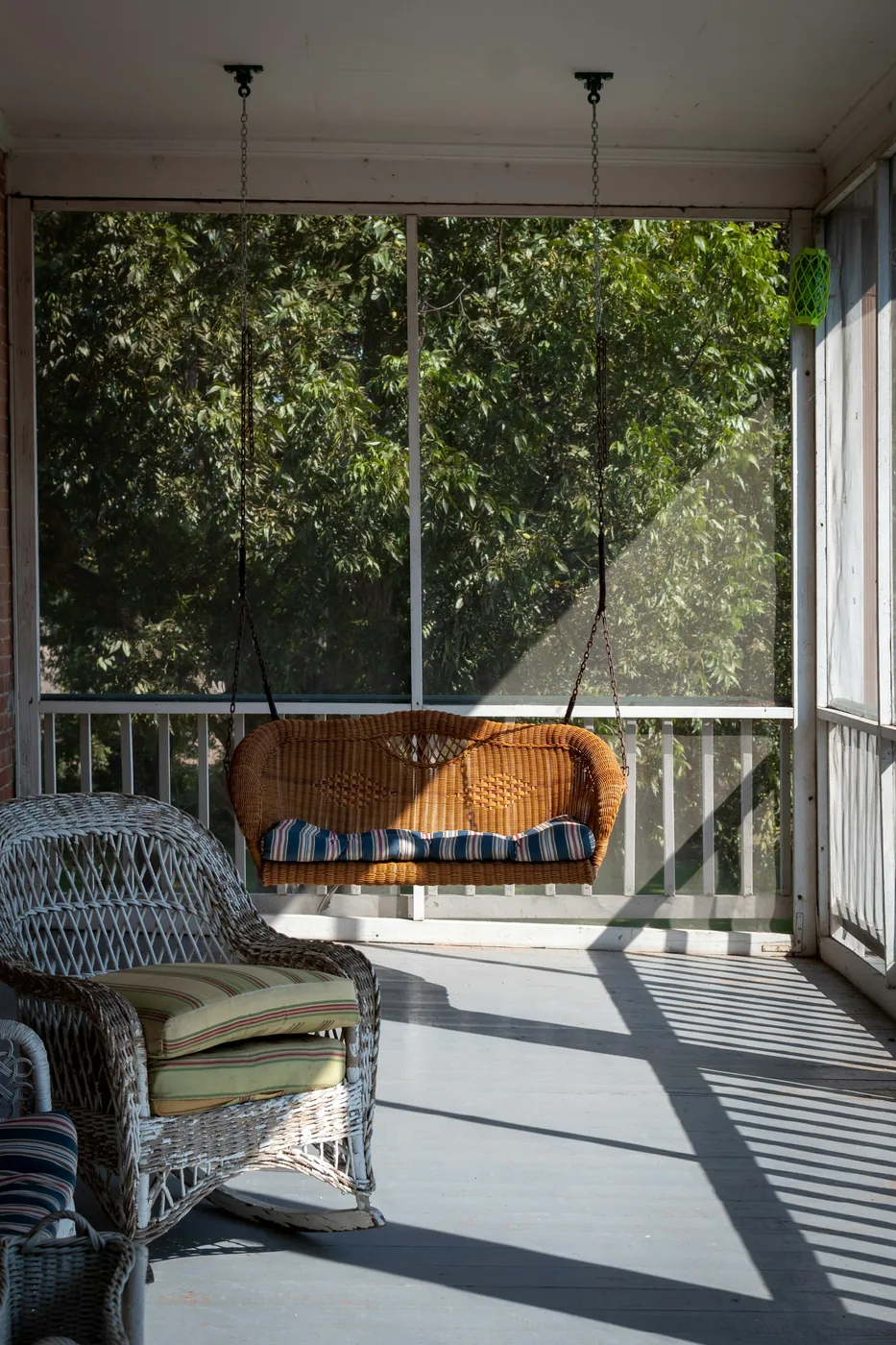 An apartment balcony enclosed with framed mosquito mesh panels