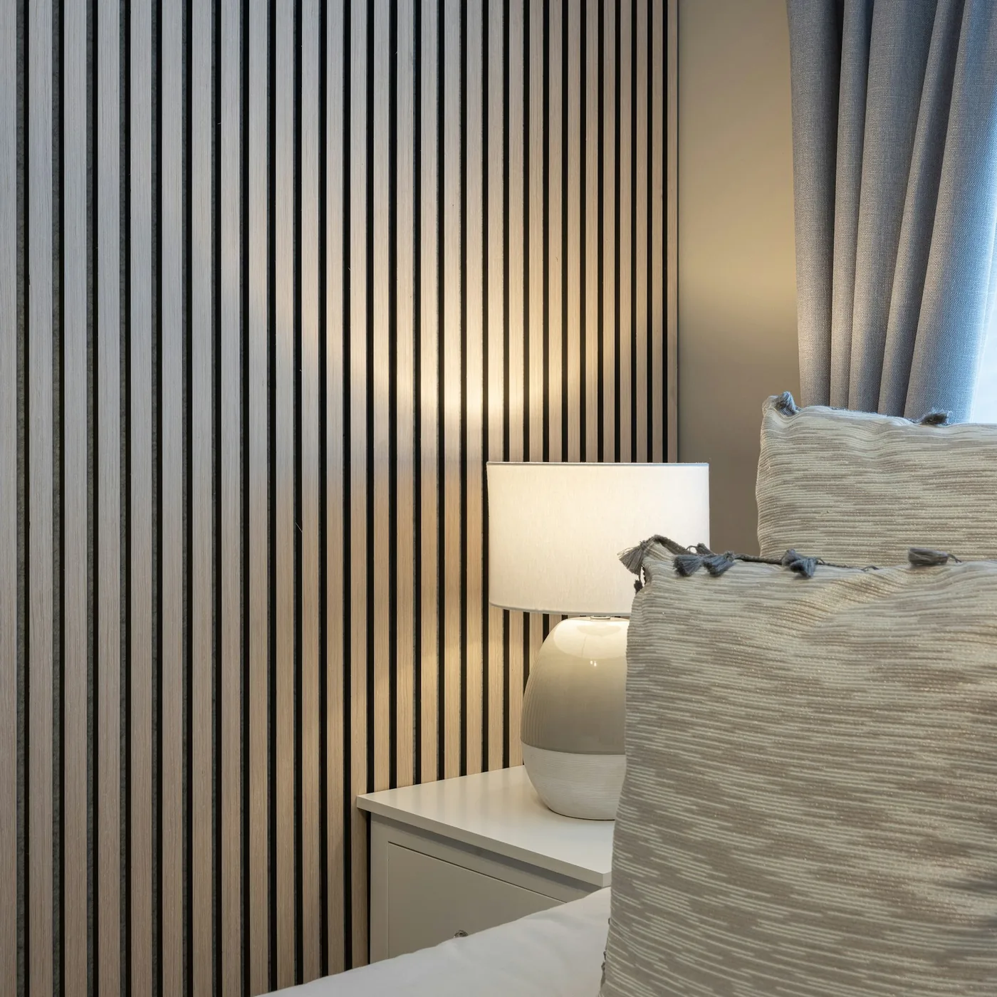 Slatted charcoal louver panels in a wood finish on a feature wall