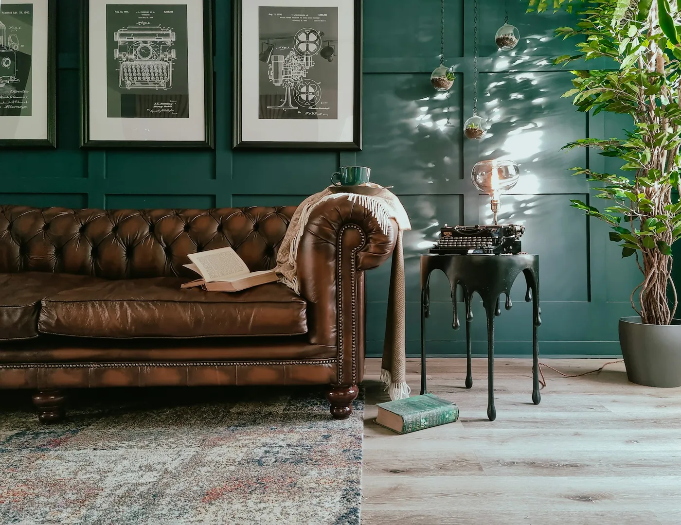 A deep-buttoned chesterfield sofa with rolled arms in a high-ceilinged room