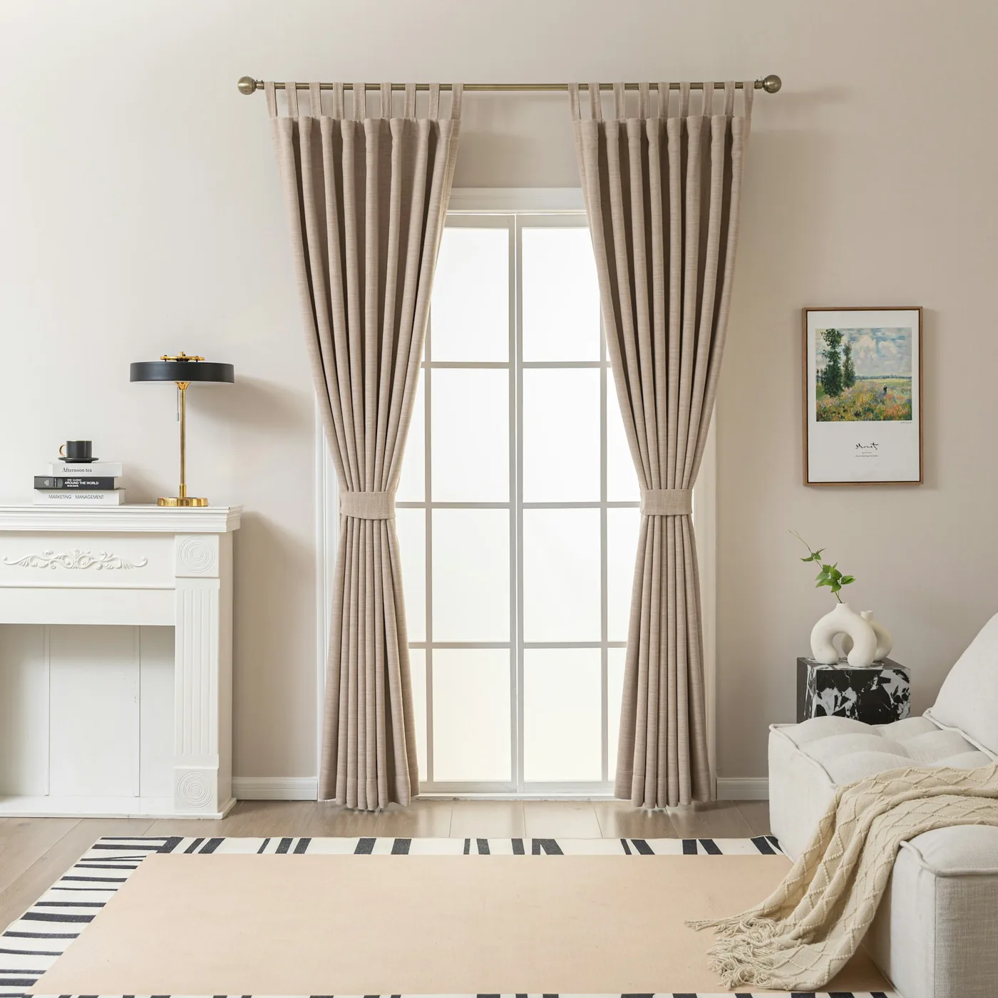 A metal curtain rod with rings and a finial on brackets above a window