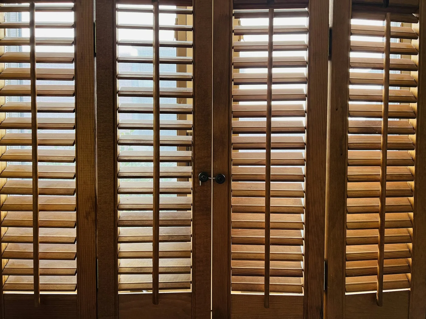 Vertical WPC louvers screening a verandah with light passing between the slats