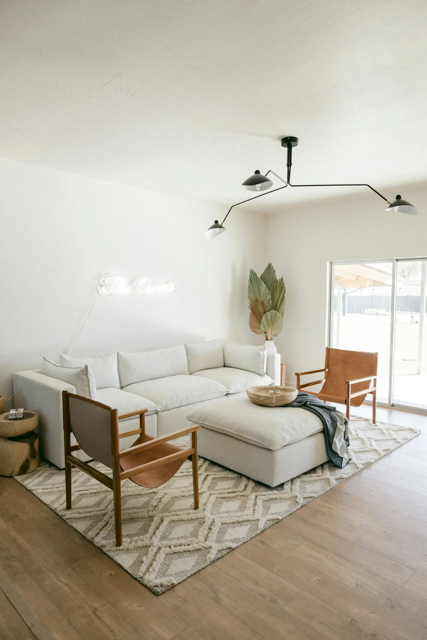 A geometric patterned rug in a bright contemporary living room