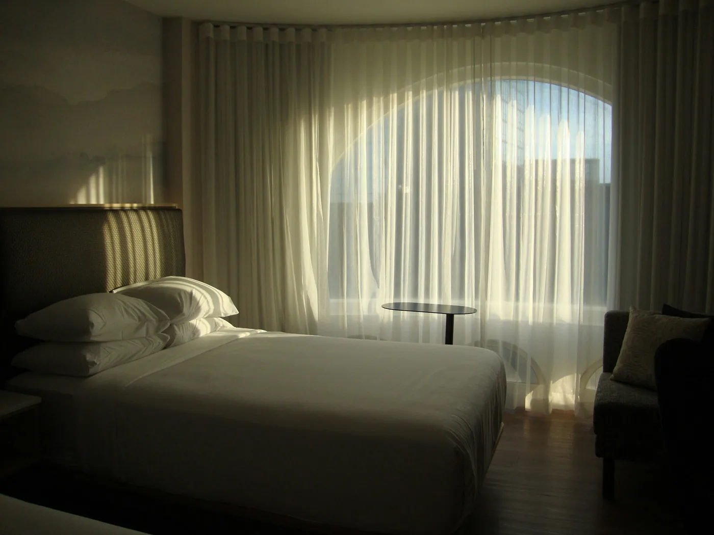 A motorised curtain track with the motor unit at one end, fixed to a ceiling