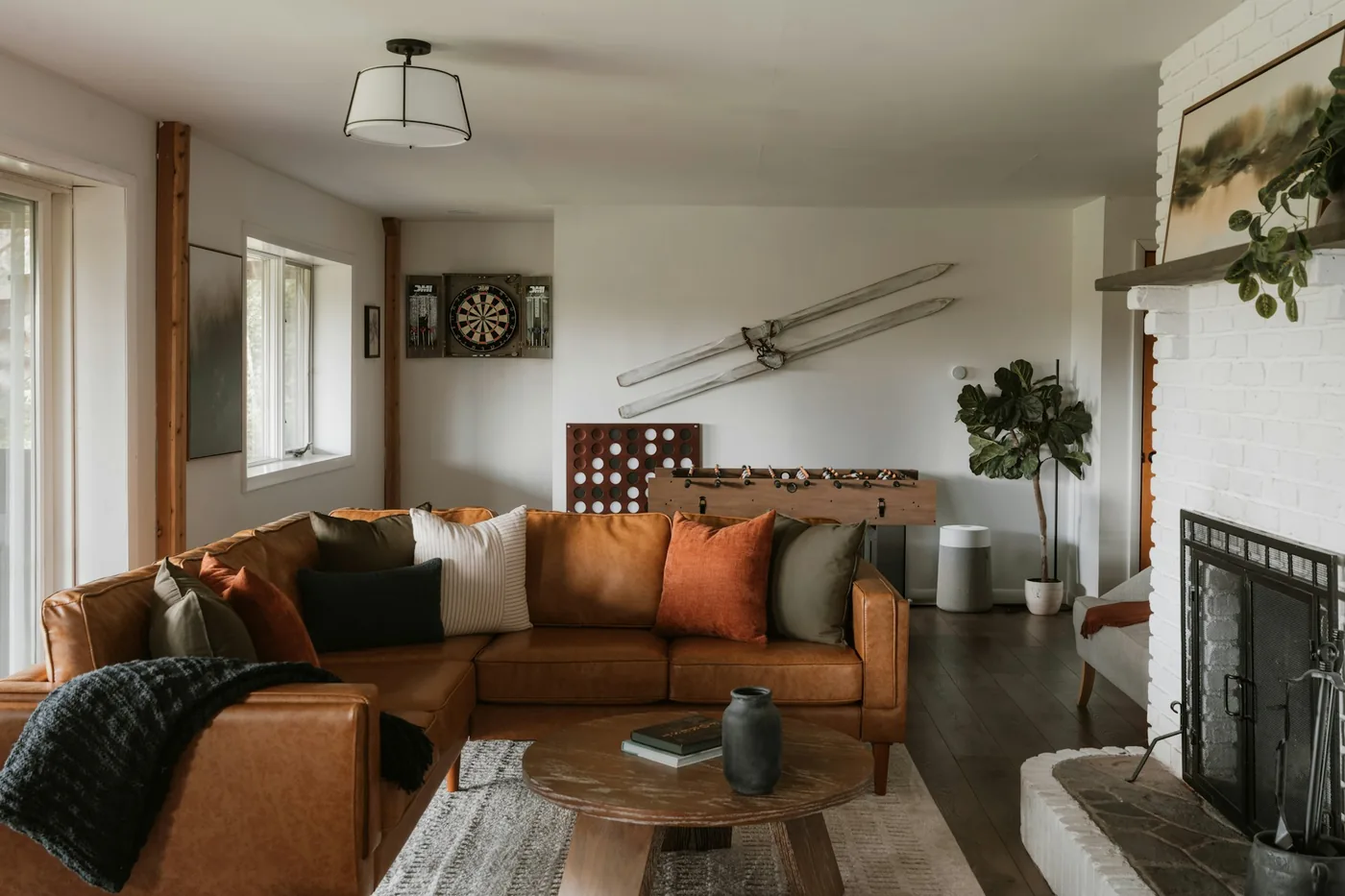 A modular corner sofa made of separate upholstered units arranged in an L around a rug