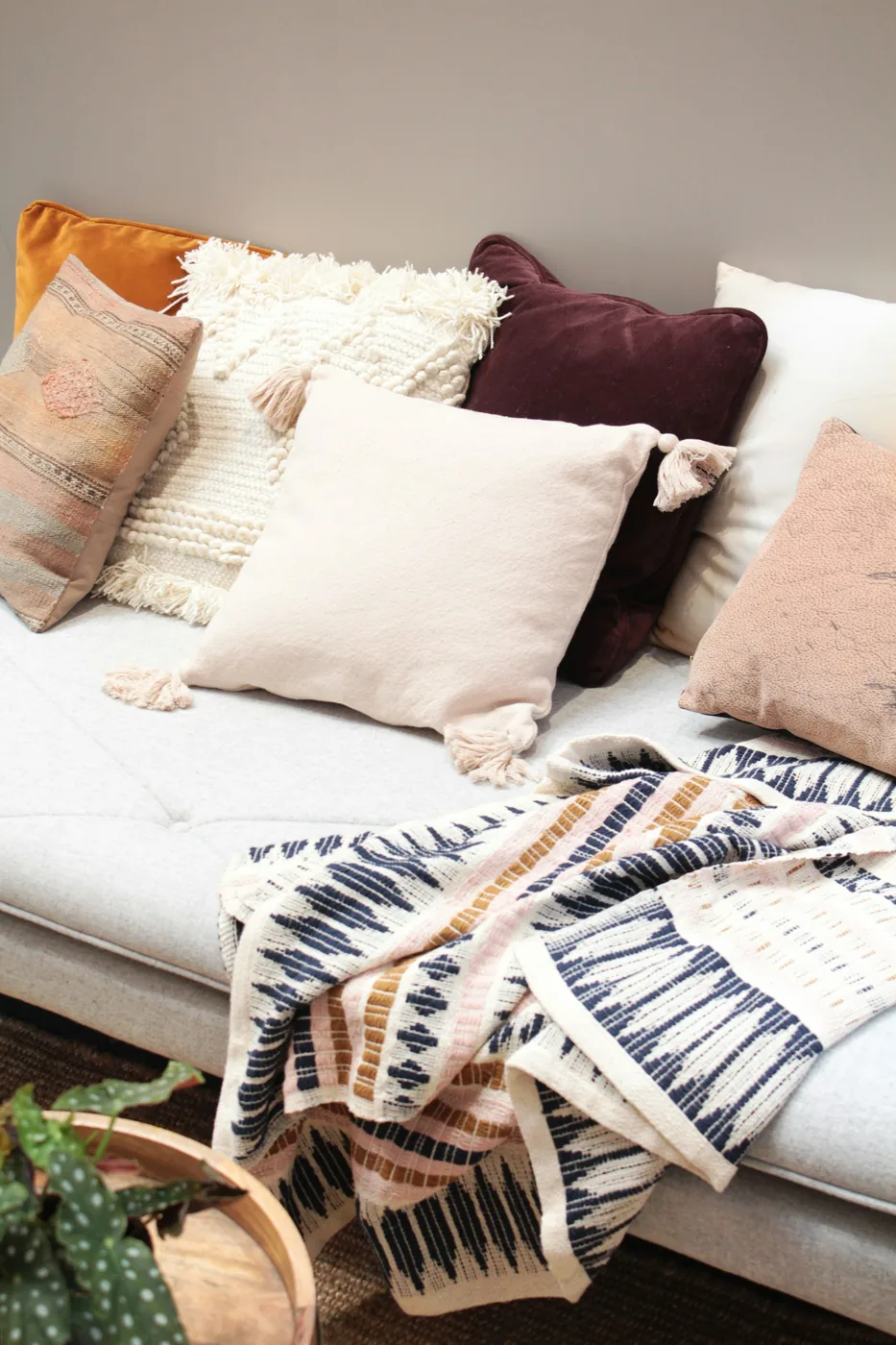 Sofa seat cushions and throw cushions arranged on a fabric sofa