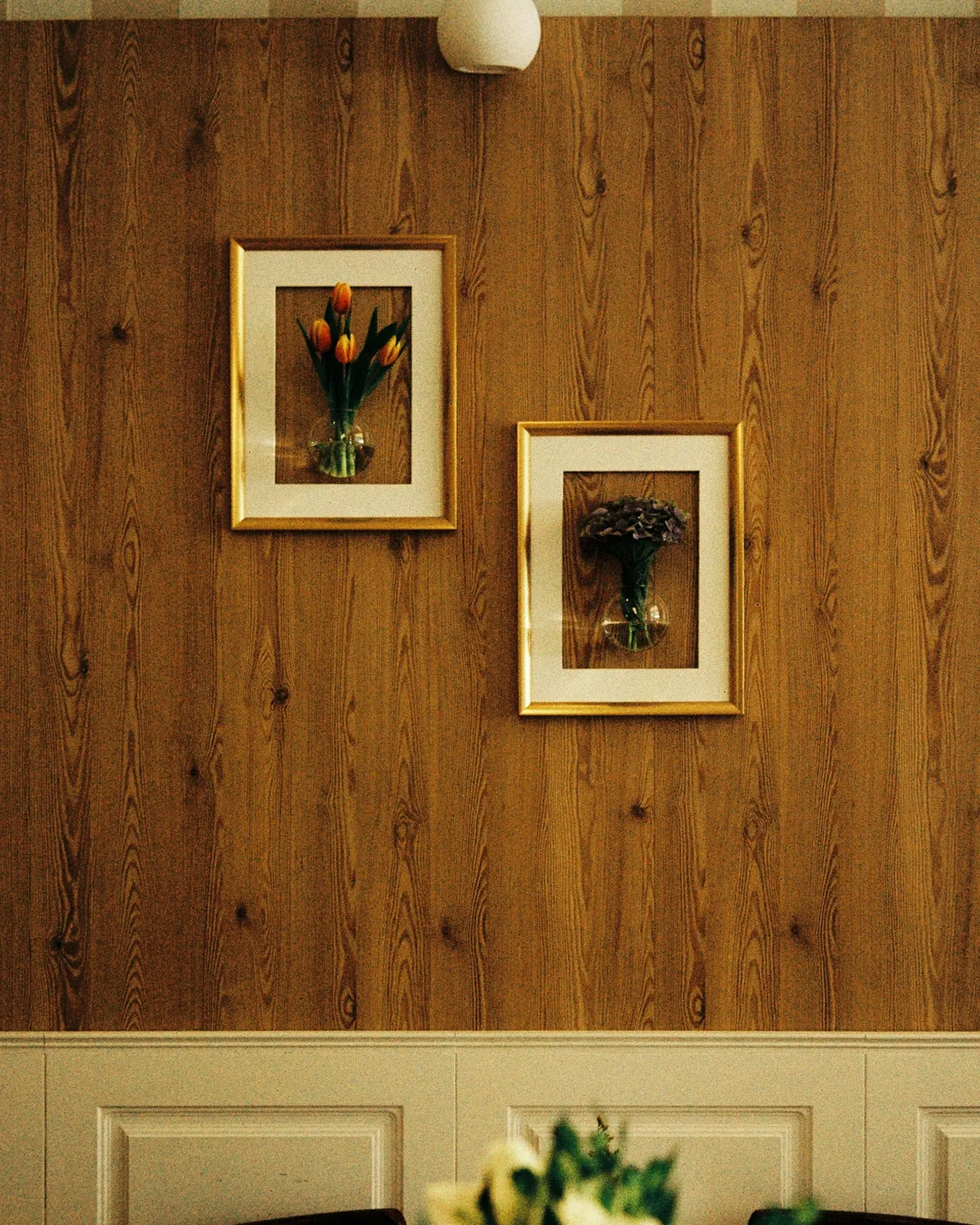 Natural wooden wall panels on a bedroom wall behind a bed