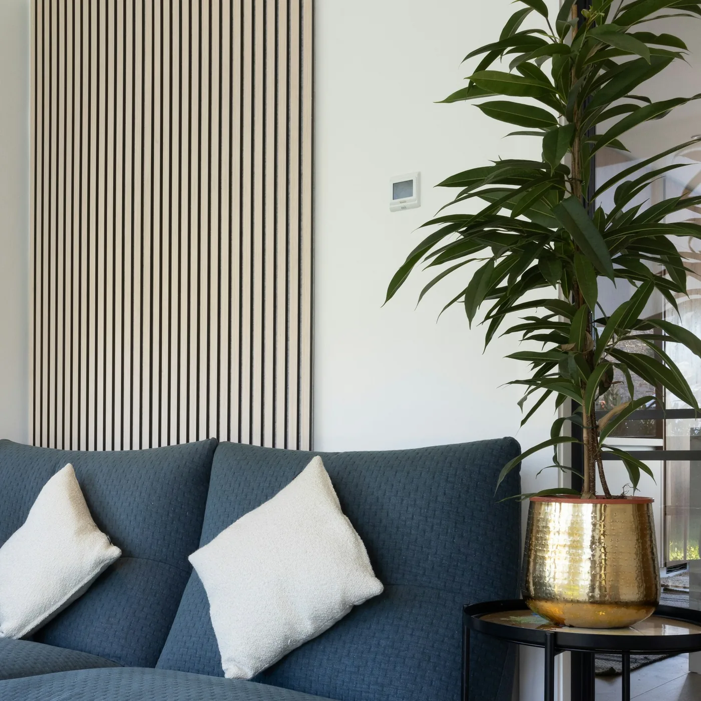 WPC wall panels in a warm wood tone on a living-room wall