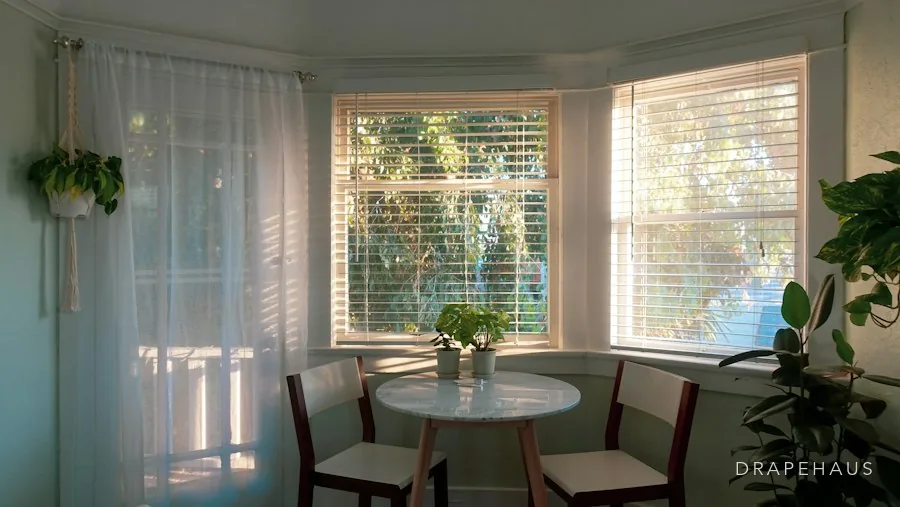 Arched window in a Goan house with a curtain hung on a straight pole above the arch