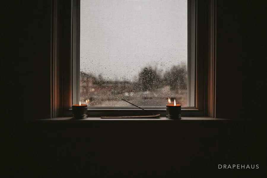 Heavy monsoon rain against a window of a Goan home