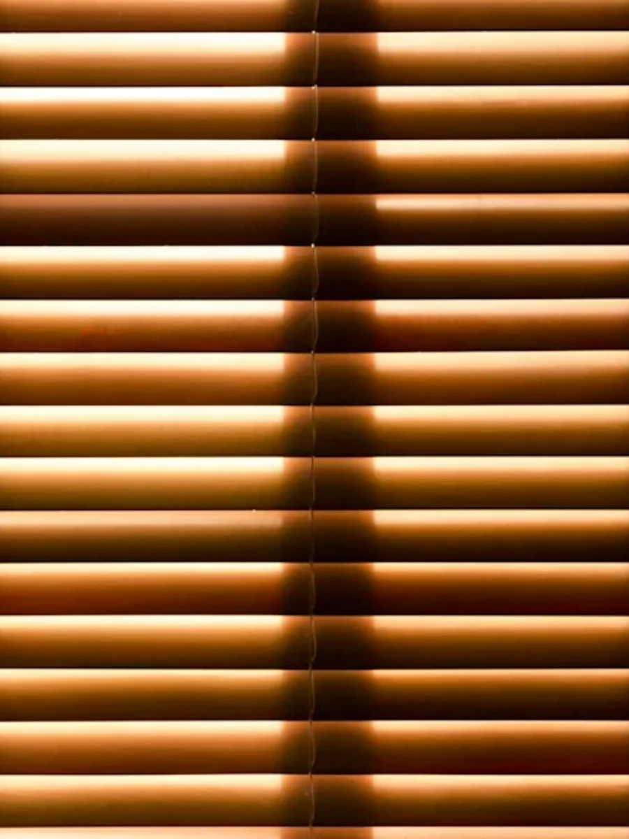 Wooden venetian blind at a window in a Goan home