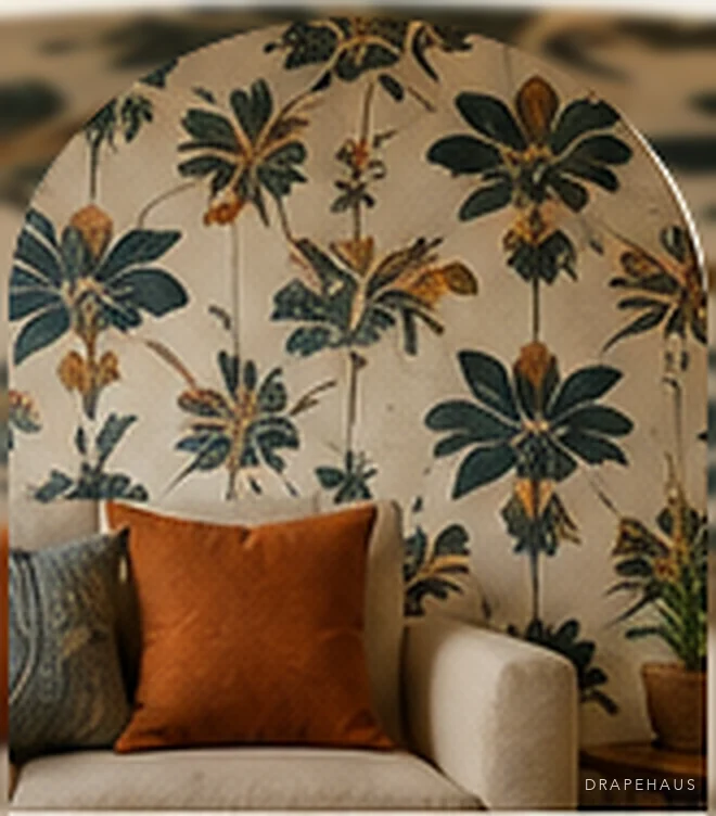 Indigo and ochre botanical wallpaper behind a low armchair