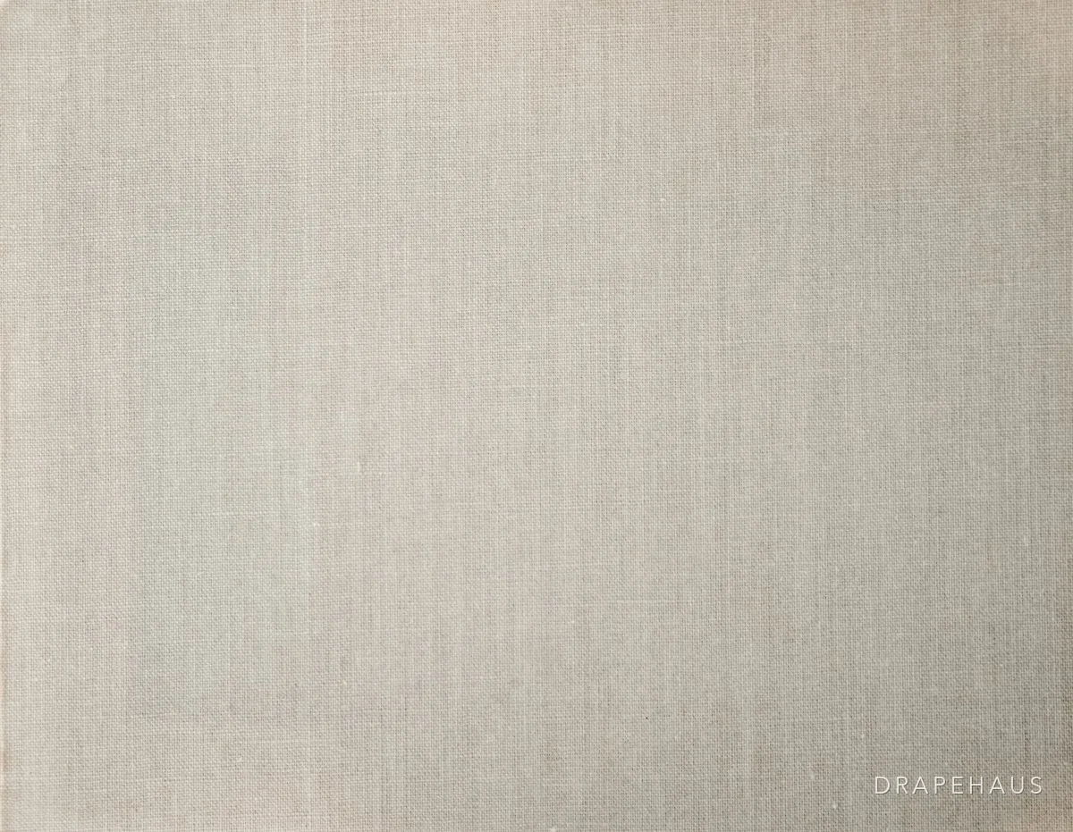 Natural linen curtain fabric falling in soft folds