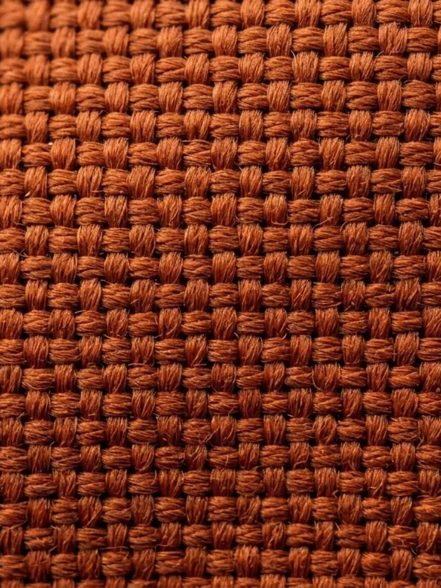 Close-up of a coarse solution-dyed outdoor canvas in burnt orange