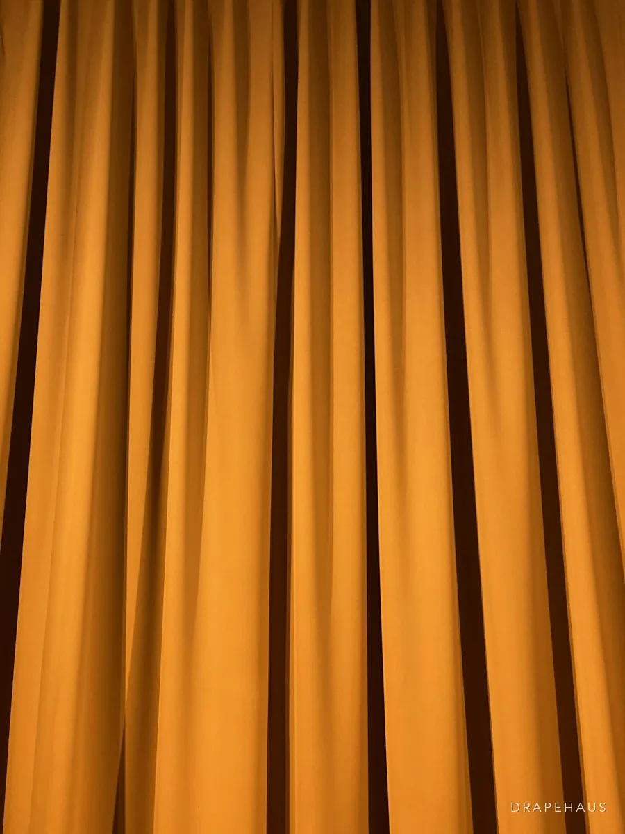 Heavy velvet curtain falling in a high-ceilinged Goan room
