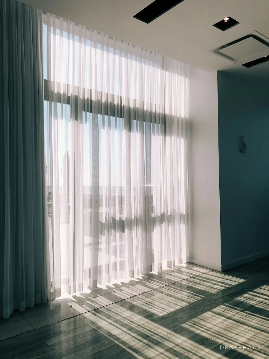 Guest bedroom in a Goan homestay with blackout curtains partly drawn