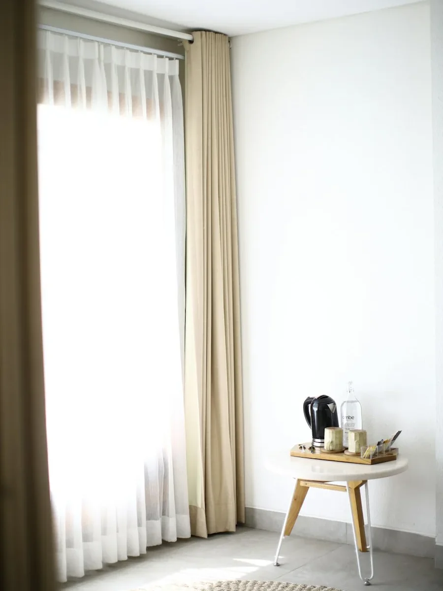 Neutral, well-lit rental flat interior in Goa with simple roller blinds