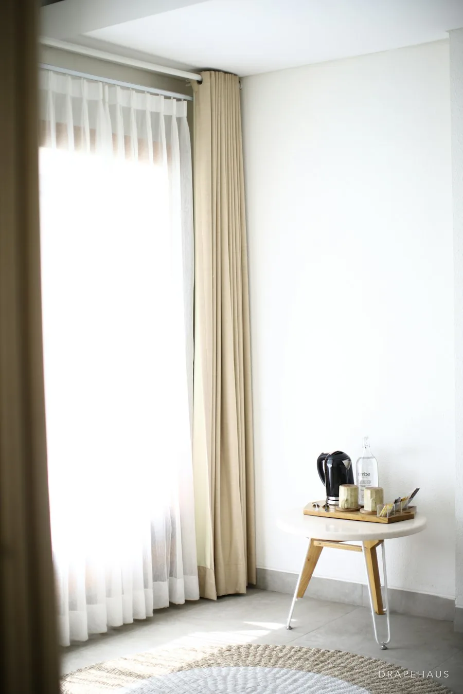 Neutral, well-lit rental flat interior in Goa with simple roller blinds
