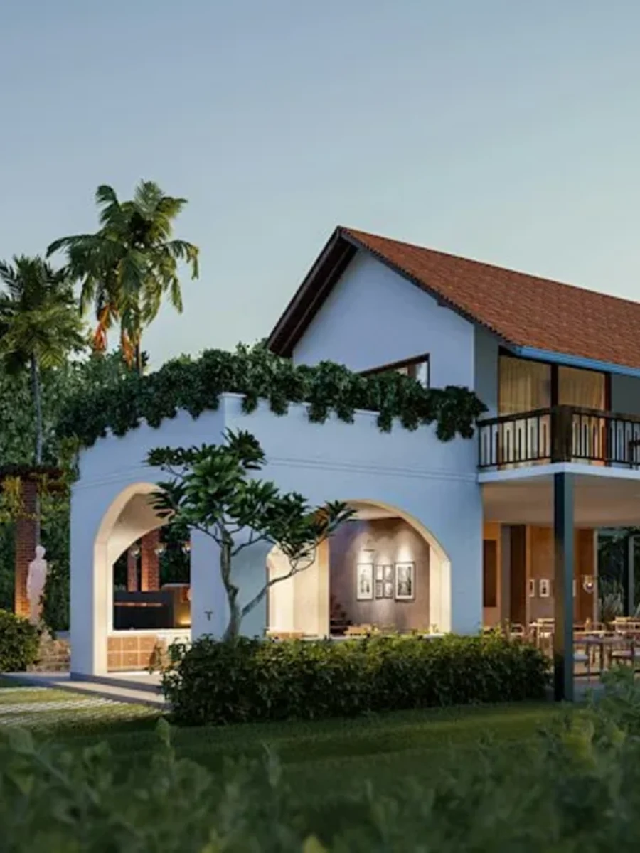 Restored Goan farmhouse interior where an original wall meets a modern glazed extension