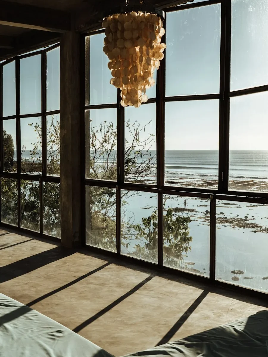 Sea-facing living room with full-height terrace doors and an uninterrupted horizon