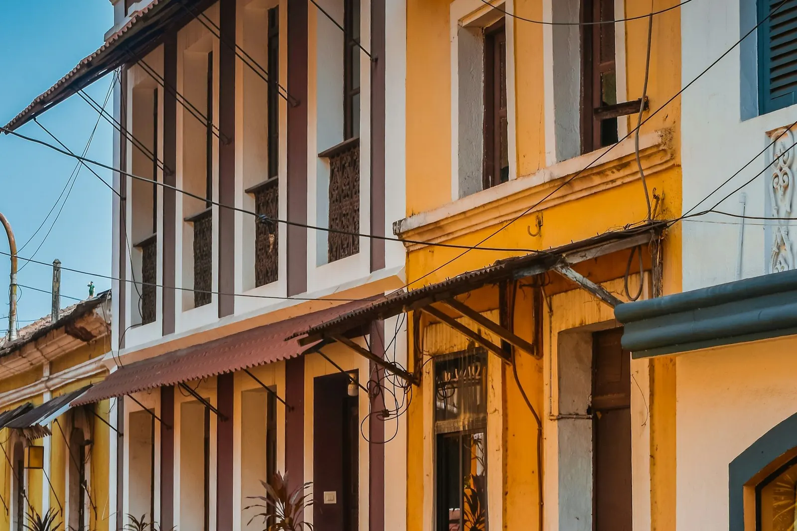 Row of colourful Portuguese-era townhouses with balconies and awnings in Fontainhas, Panjim