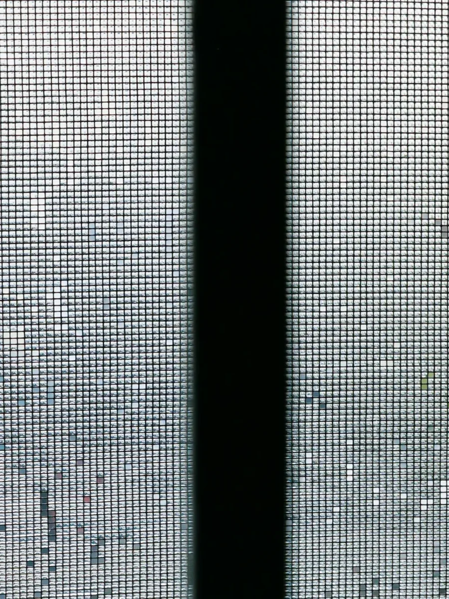 Close view of fine insect mesh on a window screen divided by a black frame