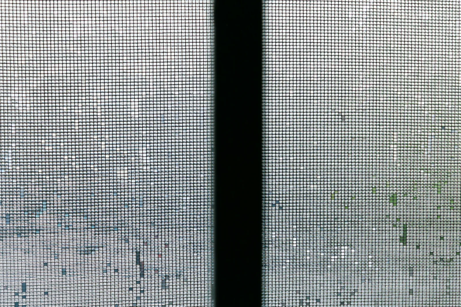 Close view of fine insect mesh on a window screen divided by a black frame