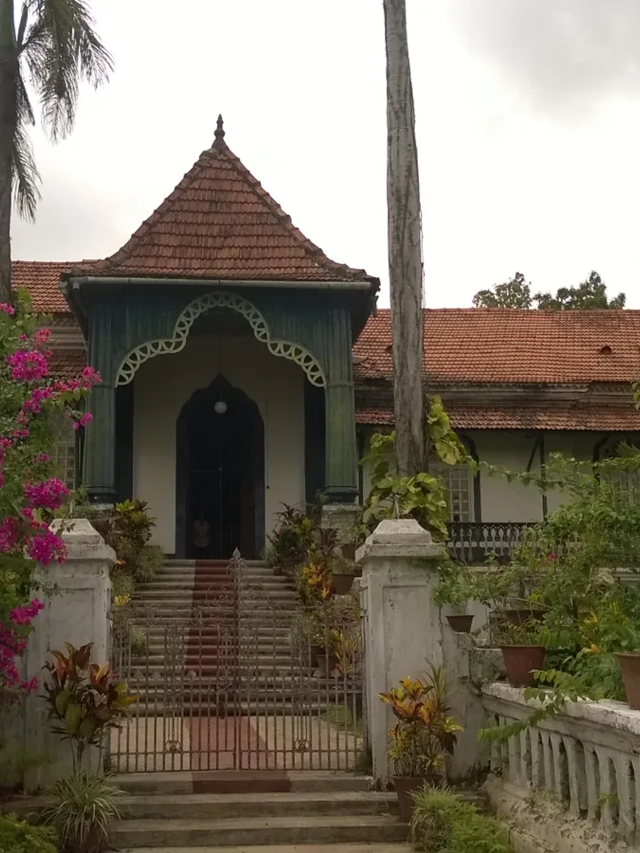 The Figueiredo mansion in Loutolim, a tiled-roof Goan house with porch, stone steps and bougainvillea