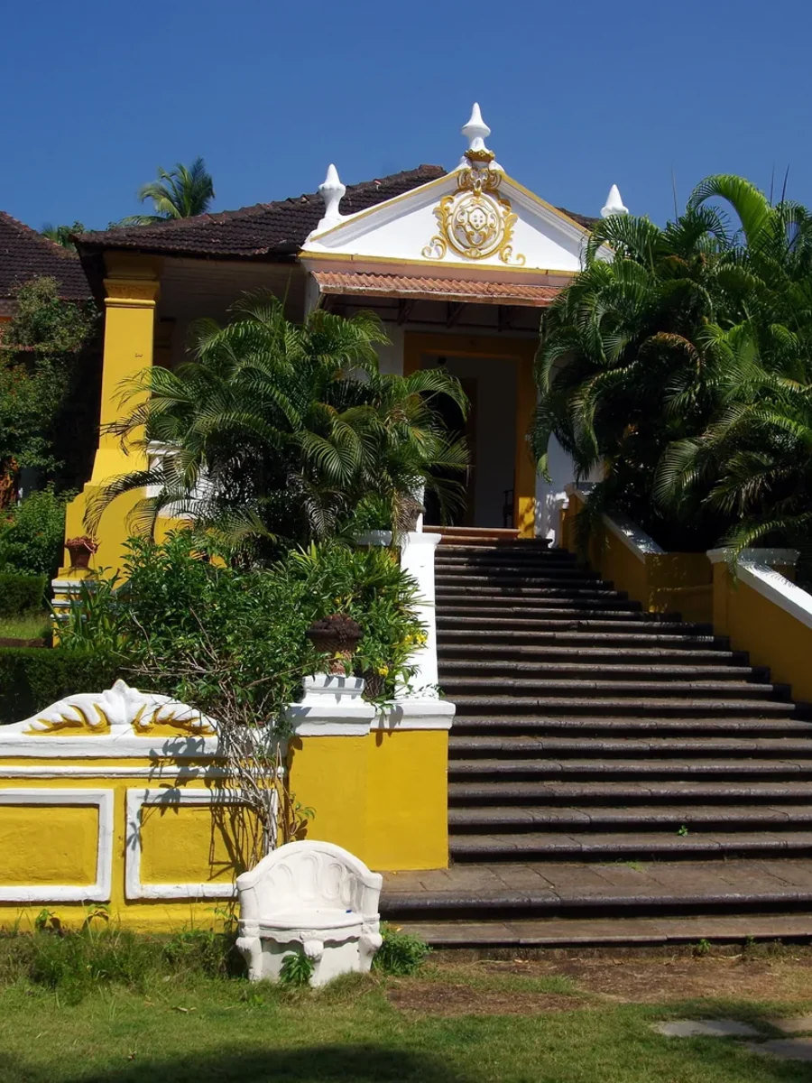 The yellow-and-white Palácio do Deão in Quepem, a Portuguese-era Goan house approached by a broad stone stair