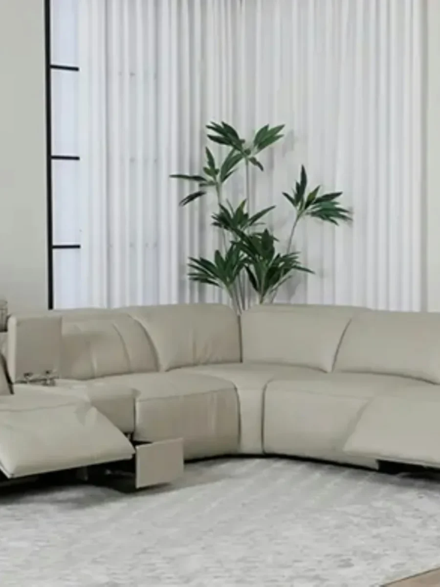 Beige leather corner sofa with two power-recline seats extended in a bright living room
