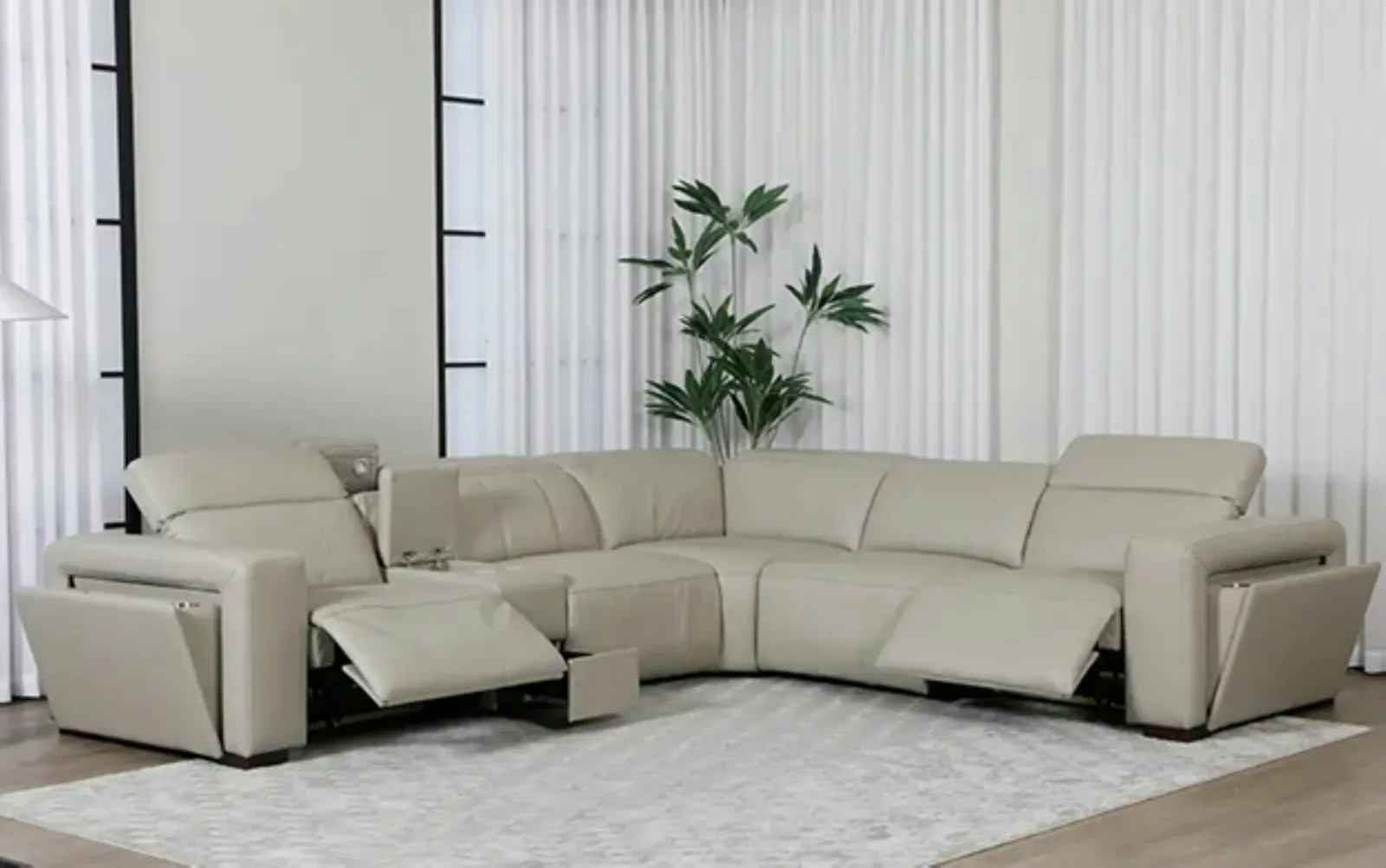 Beige leather corner sofa with two power-recline seats extended in a bright living room