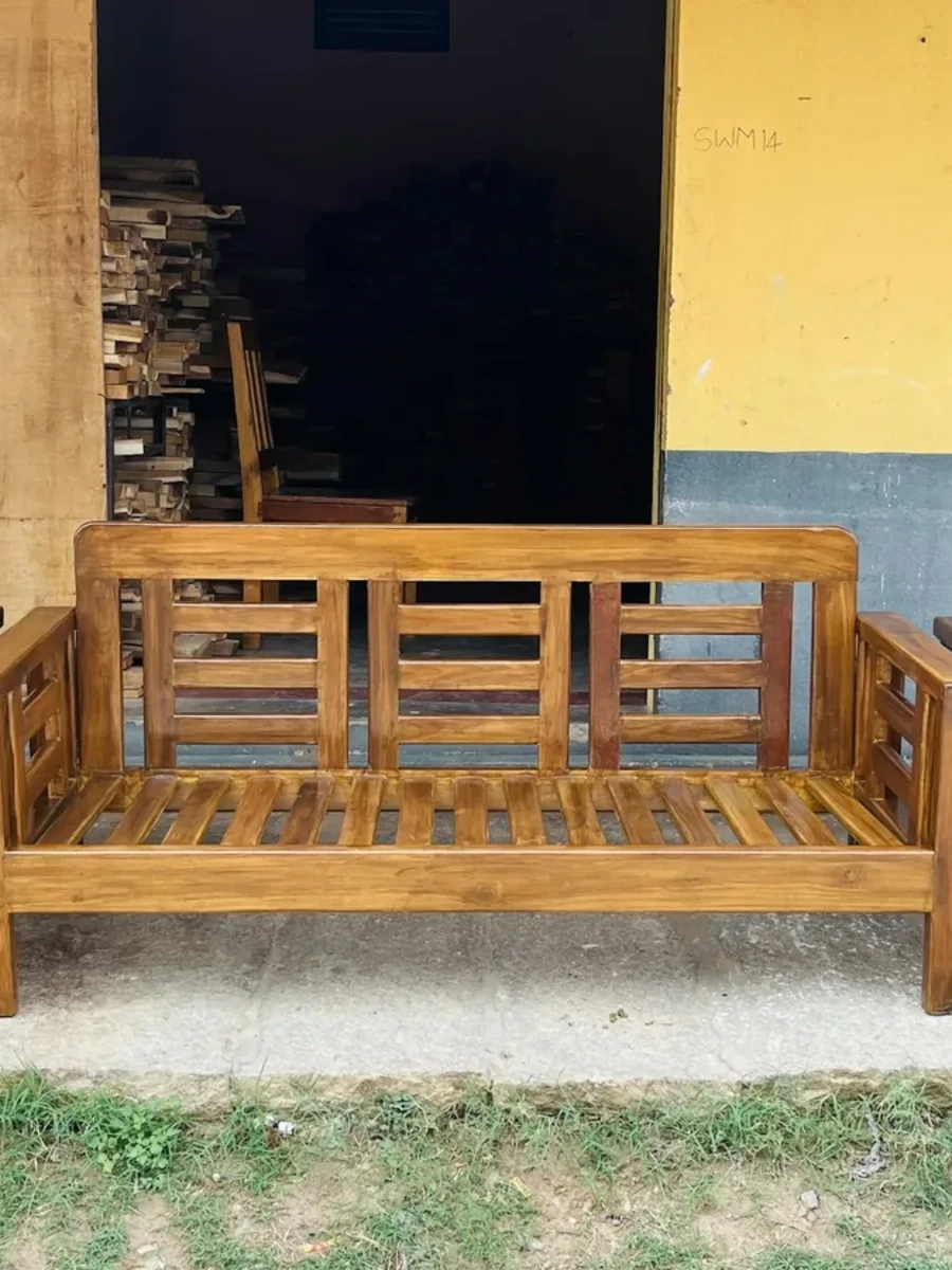 Solid wood slatted sofa set, a three-seater and two armchairs, outside a timber workshop