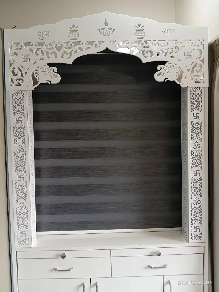 The same mandir unit with the zebra blind fully lowered and the shelves empty