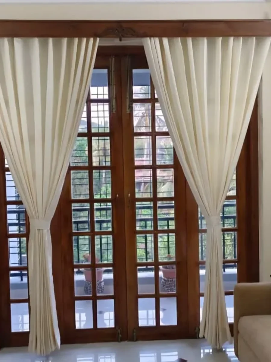 Tall shuttered window in a Goan Portuguese-era house with a deep plastered reveal