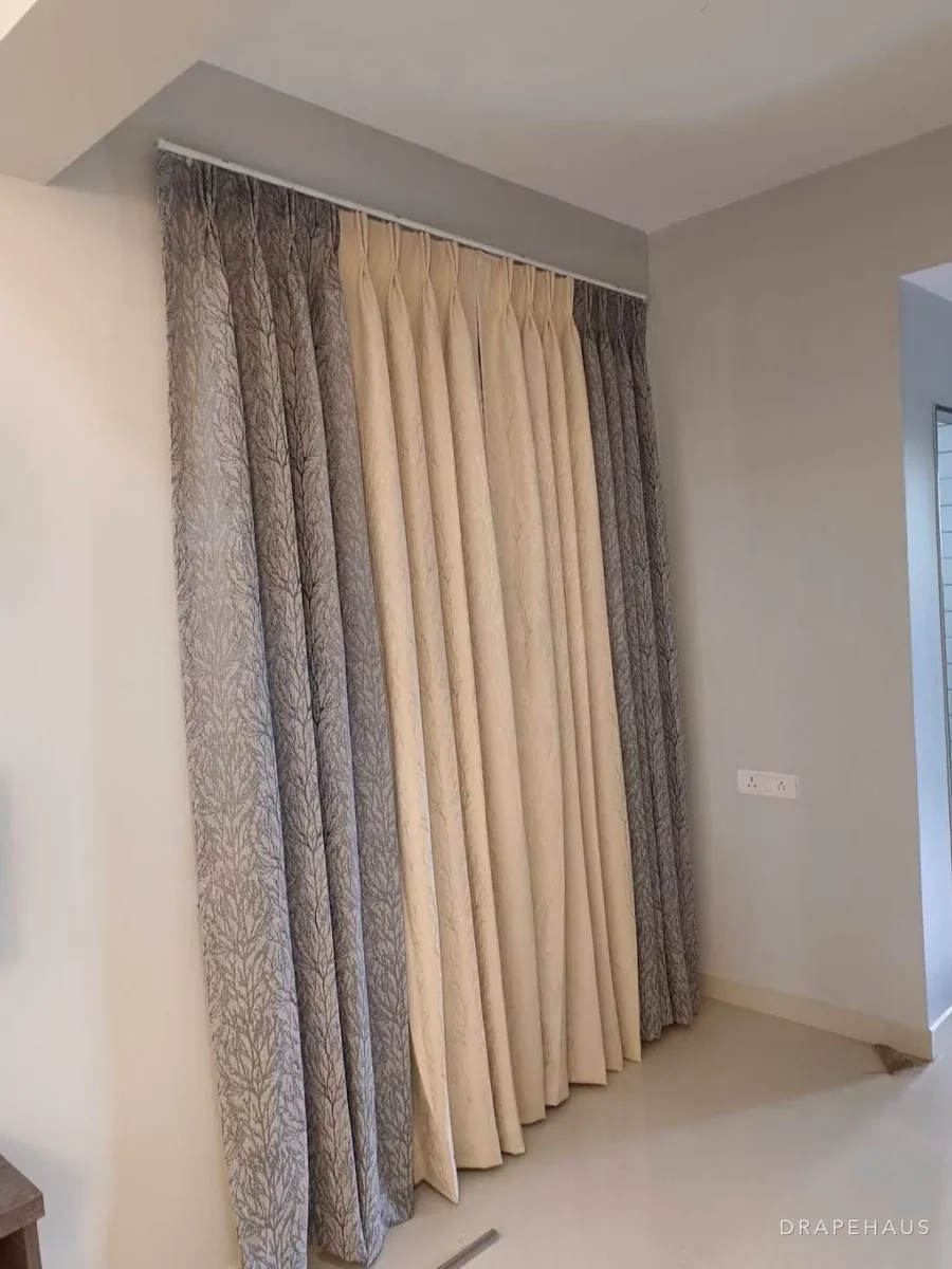 Floor-to-ceiling curtains on a ceiling track, gathered at generous fullness