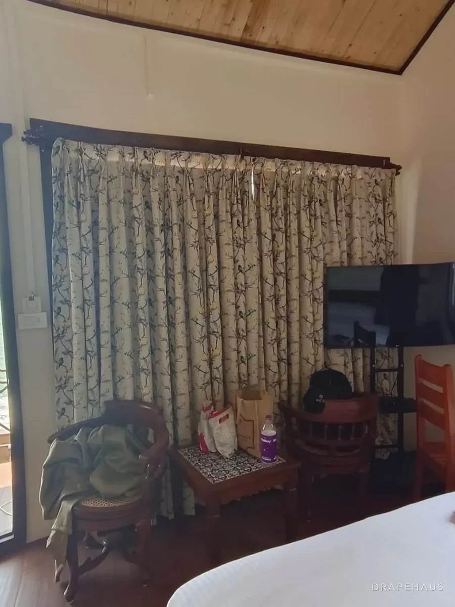 Patterned curtains hung high and wide in a resort guest room