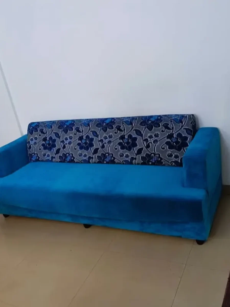 A two-seater sofa recovered in teal fabric