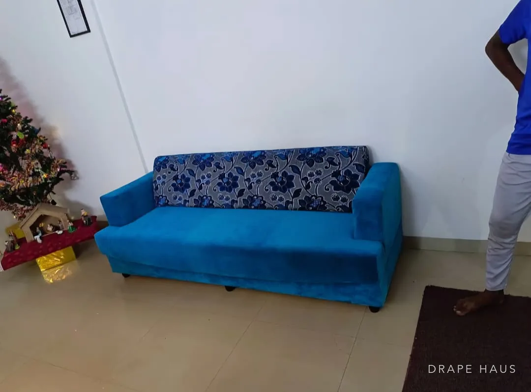 Three-seater sofa reupholstered in teal velvet with a patterned damask back panel