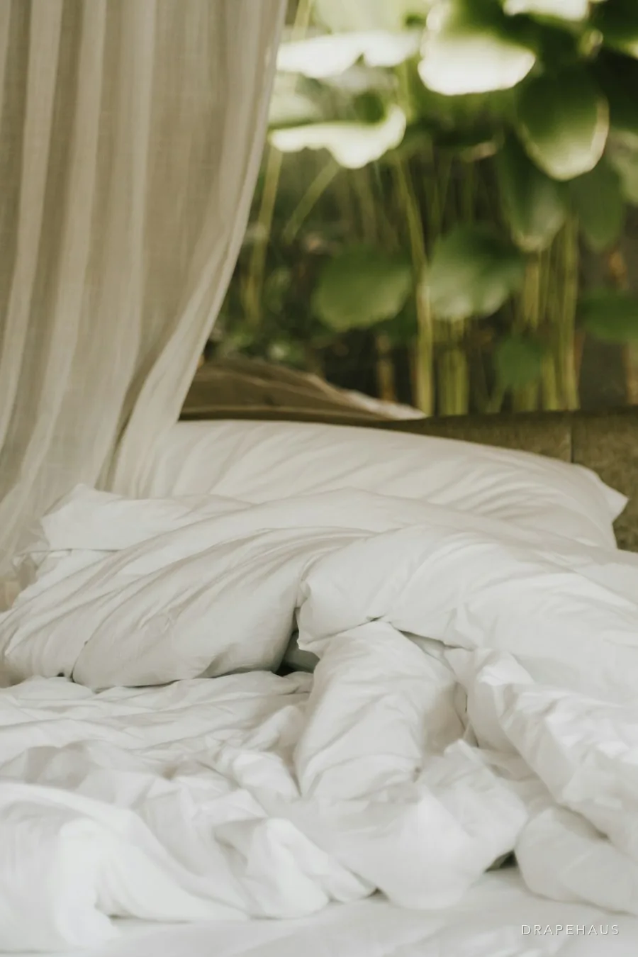 An upholstered headboard behind a freshly made bed