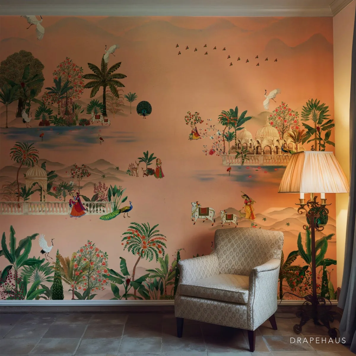 A botanical mural wallpaper behind an armchair in a living room