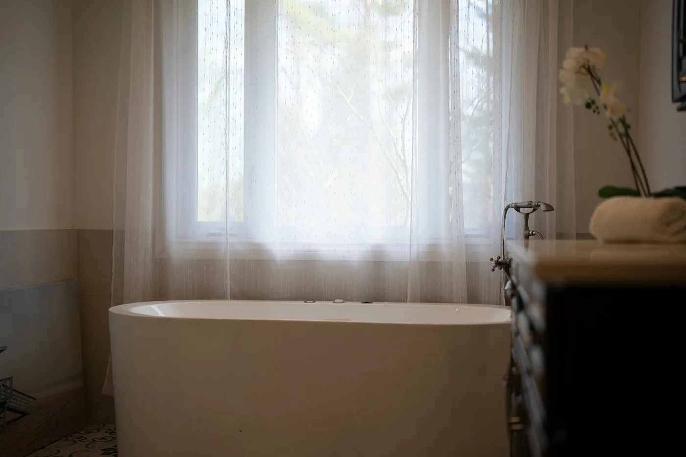A bright bathroom with a window blind and light-coloured wall finish