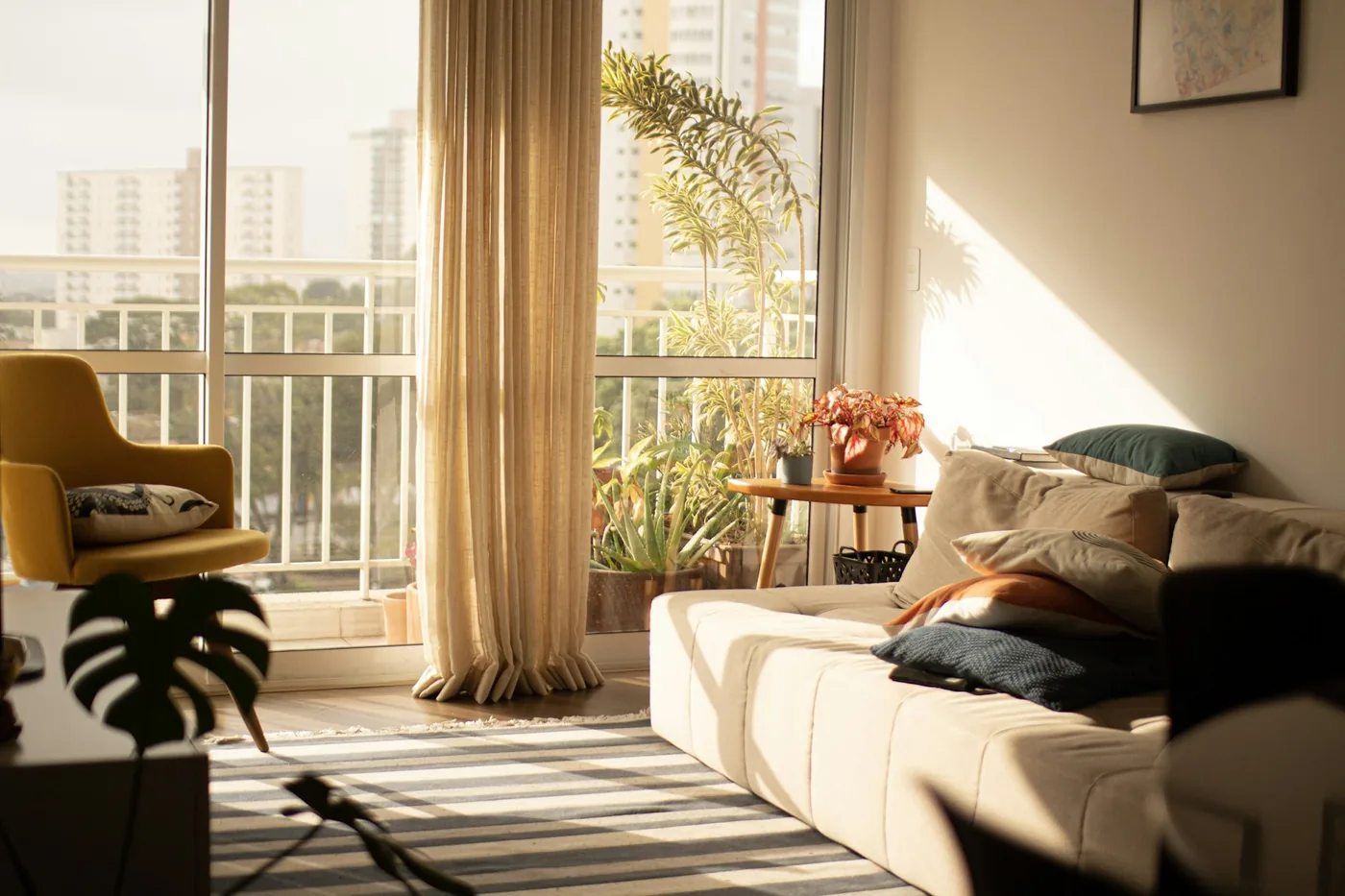 A furnished apartment living room in Goa with curtains on a sliding window